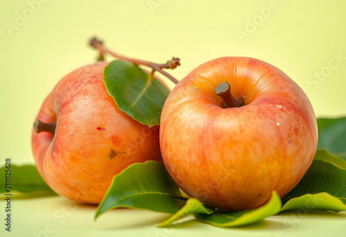 Two fresh red apples with g...