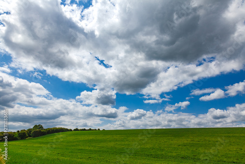 Green Farmland Beneath Dramatic Clouds in Kent England