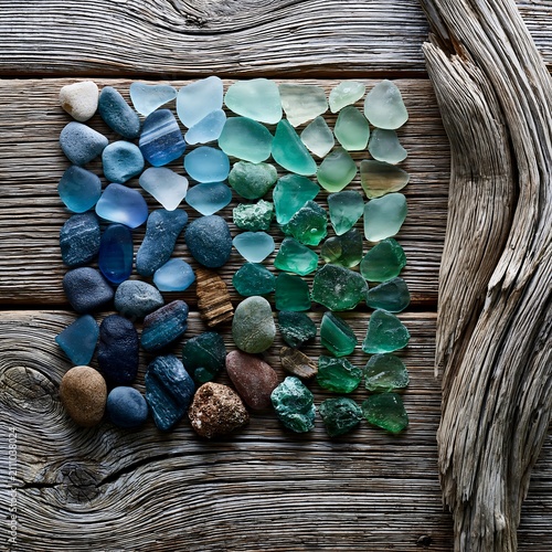 Colorful Sea Glass, Smooth Stones, and Driftwood on Weathered Wood