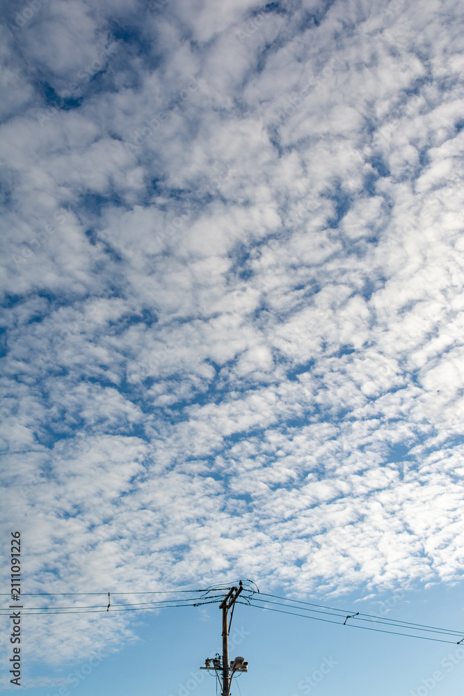Obraz premium Utility pole under a cloudy sky