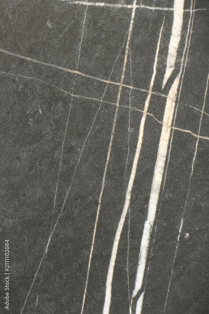 Fototapeta premium Black marble surface showing white vein patterns