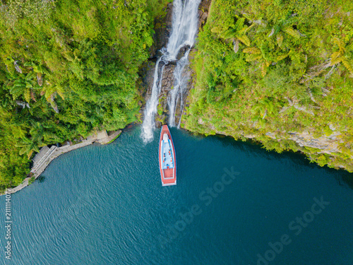 Fotografie Aerial drone view of greenery hills with Situmurun Waterfall near Toba Lake at L