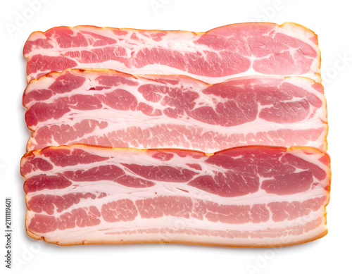 Studio shot of slick fatty processed bacon slices with artificial pink hues on white