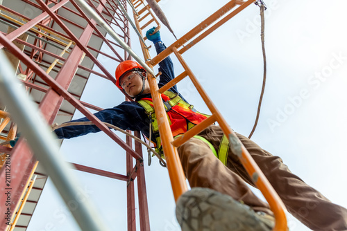 Construction worker climbing ladder