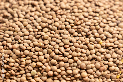 Canvastavla Close-up of dry brown lentils scattered in bulk for food ingredient photography