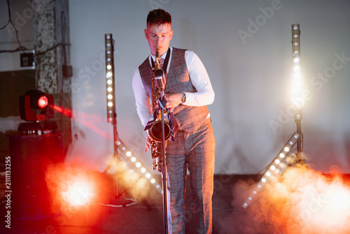 Cuadro en lienzo A professional male saxophonist in a formal grey suit performs a soulful jazz so