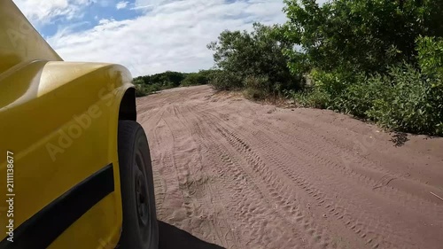 Side-Mounted POV of a Dune Buggy Driving on a Sandy Coastal Trail in Brazil