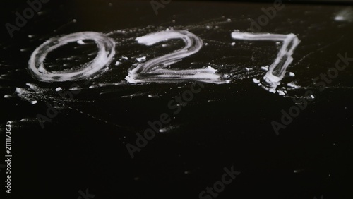 Obraz na plátně The number zero two seven 027 handwritten in white chalk on a black chalkboard surface