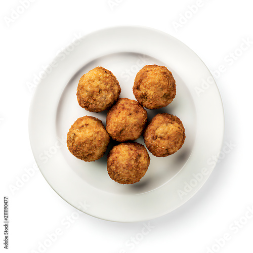 Top-down view of six golden-brown savory arancini served on a clean white ceramic plate
