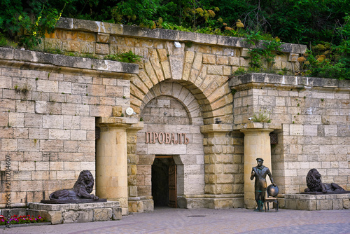 фотографія Entrance to the Proval Lake cave with a statue of Ostap Bender in Pyatigorsk, St