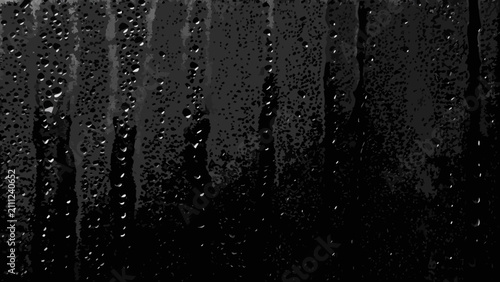 Bild auf Leinwand Water droplets on a dark surface create a textured grayscale pattern with streak