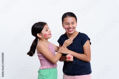 Canvastavla A little girl and a young woman drawing faces on a white background