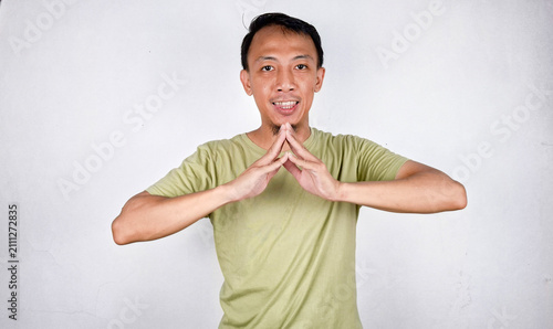 Obraz na płótnie Young handsome Indonesian man making A gesture using his hand