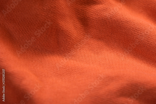 Close-up of an orange fabric background.