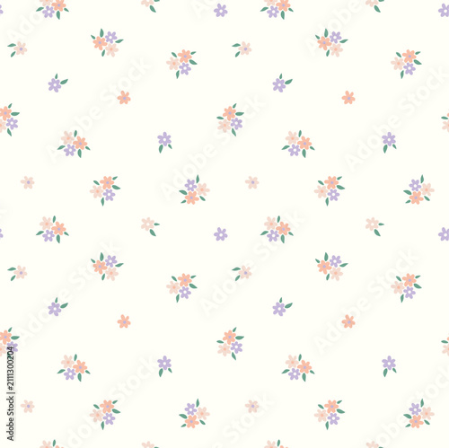Delicate floral pattern with small pastel blooms on a cream background for feminine design concepts