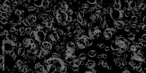 Glass surface with water drops. Clear water bubbles rising in black background. Closeup - rain water drops behind glass look like bubbles in black liquid.

