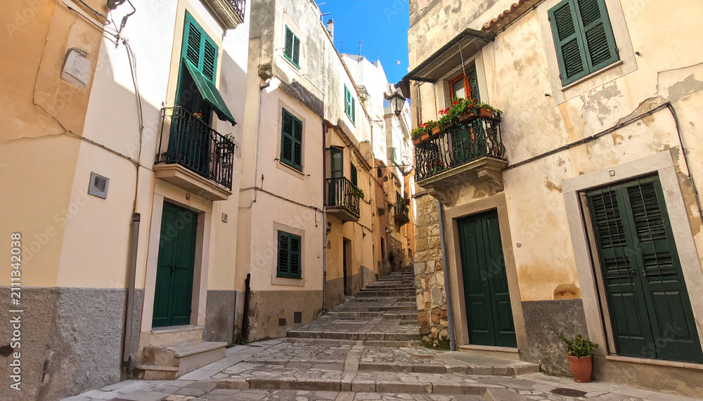 Fototapeta premium Narrow European Alleyway with Stone Steps and Balconies.