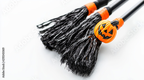 Whimsical Halloween brooms with black bristles and orange accents, featuring playful pumpkin decoration, perfect for festive celebrations