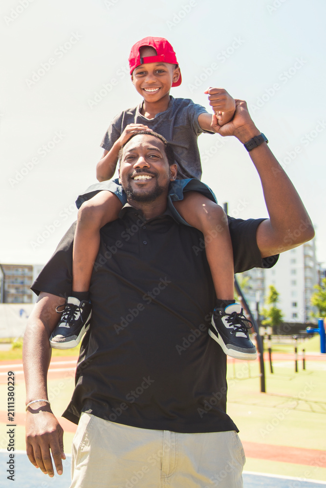 Obraz premium Father and son playing sports in sunny day at public park