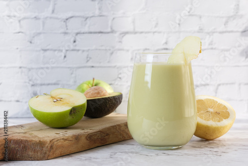 Healthy green smoothie with apple avocado and lemon