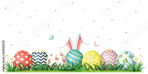 Colorful decorated easter eggs with bunny ears in green grass
