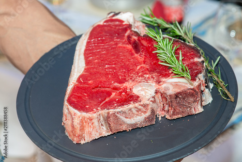 Bild auf Leinwand Raw premium steak served on white plate in luxury restaurant fine dining present