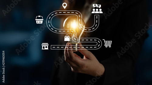 Canvastavla A dynamic business concept featuring a light bulb held by a hand, symbolizing innovative ideas and pathways, complemented by map icons that represent growth and opportunity in a modern setting