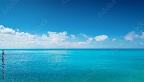 Minimalist Seascape With A Clear Turquoise Sky And Scattered White Clouds Above Calm Ocean Horizon Creating Peaceful Summer Copy Space Background