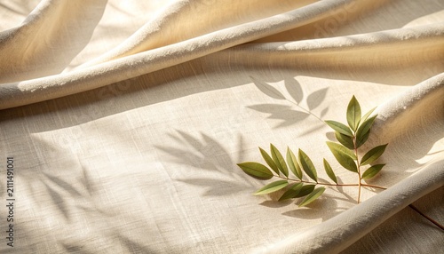 Soft botanical leaf shadows cast on a natural beige linen fabric texture with copy space