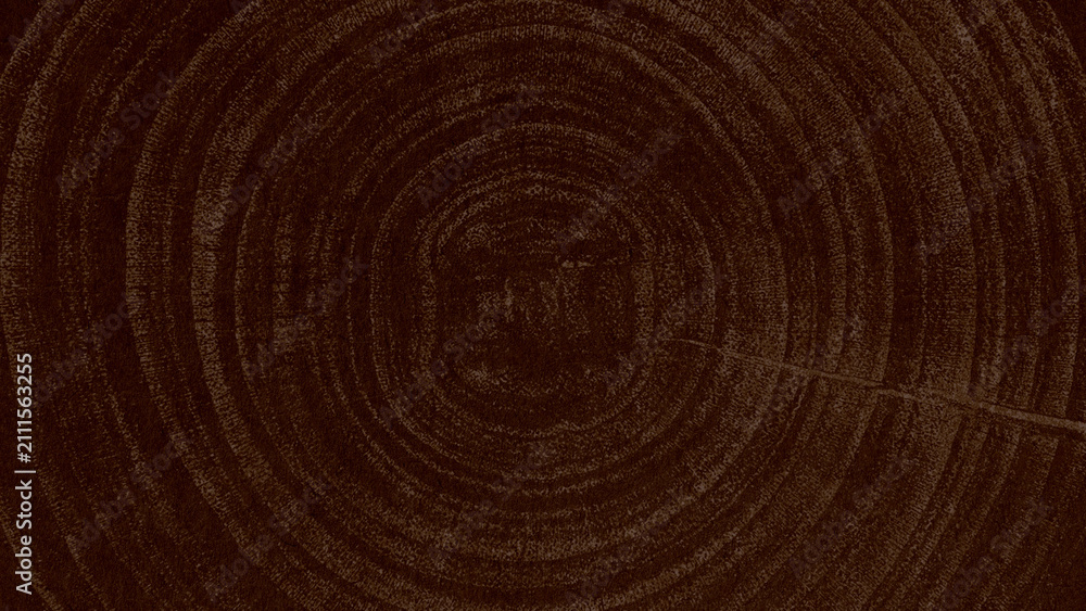 Fototapeta premium Dark brown wood grain texture with circular tree rings, rustic and natural.