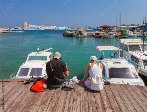 Photography People Fishing from Harbor Pier with Boats in Mandraki Port, Rhodes, Greece