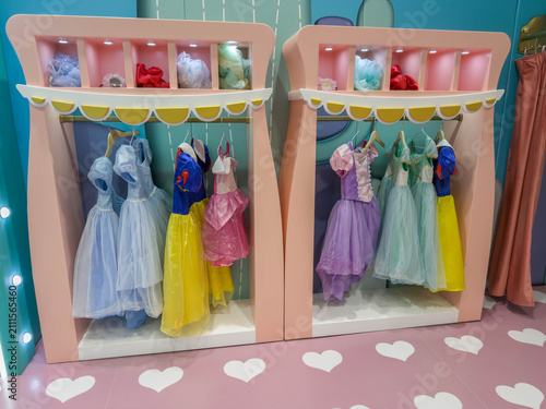 Fotografie Children's dress-up corner with colorful princess costumes displayed on racks in