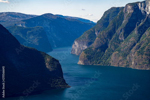 Canvas Print Layered mountains framing a winding fjord in soft daylight
