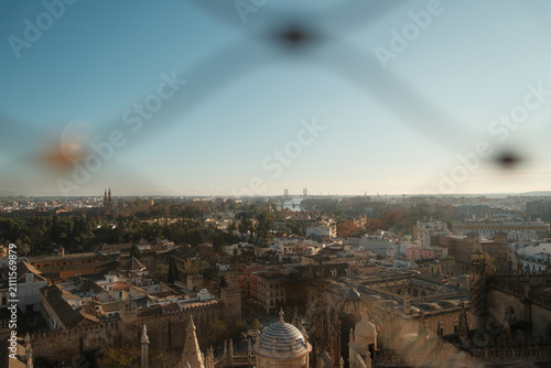 View of seville spain through wired fence