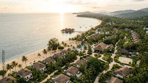 Luxury Tropical Beach Resort with Oceanfront Villas and Palm Trees at Sunset Aerial View