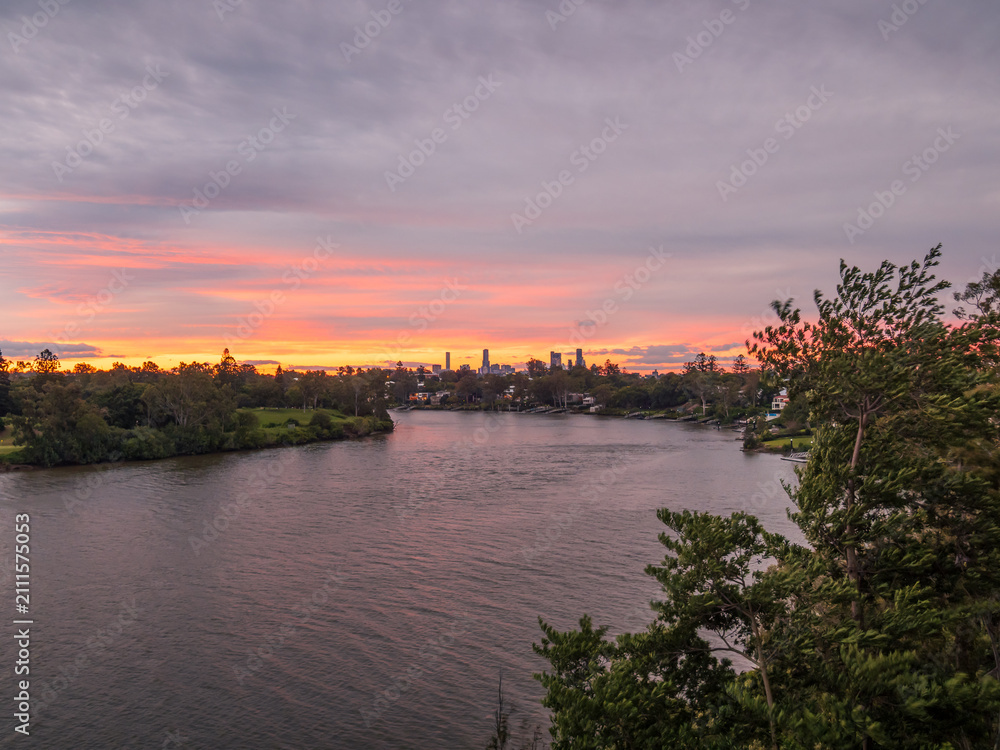Fototapeta premium Sunset Over the City with River Reflections