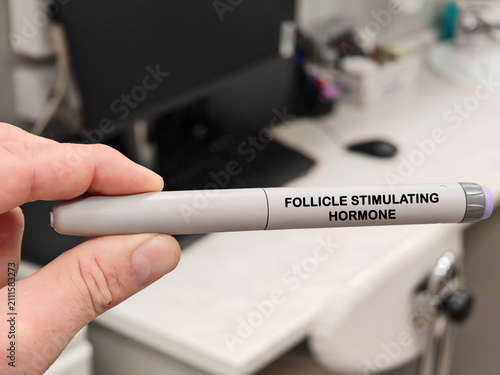 FOLLICLE STIMULATING HORMONE medical concept with an autoinjector in pharmaceutical research laboratory