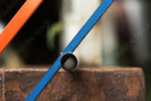 An hacksaw used in trimming a rod