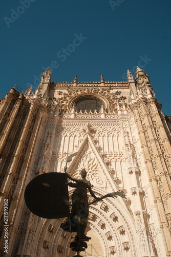  intricate exterior stonework of the Seville Cathedral, a UNESCO World Heritage site located in Seville, Spain, the largest Gothic cathedral in the world vertical