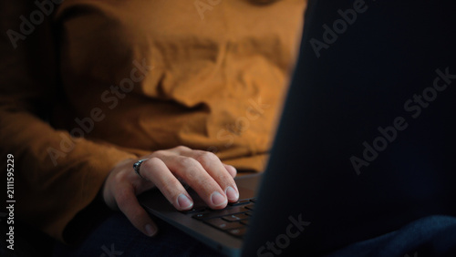 Фотография Close-up of an anonymous woman's hand using a laptop, representing digital inter