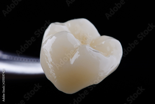 Fotografie High-quality zirconia dental crown on white background