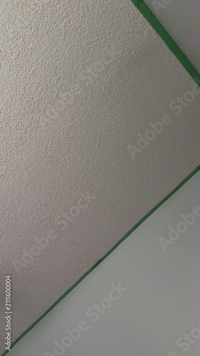 Painter’s Tape Applied Along Interior Wall and Ceiling During a Home Painting Project