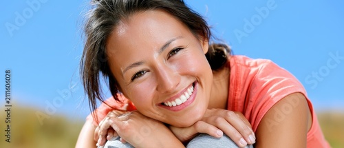 Young woman with glowing skin in a warm outdoor setting