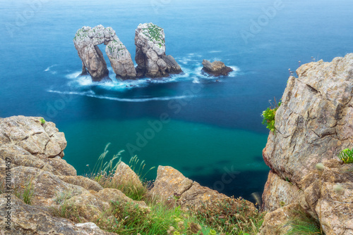 Coastal landscape of Costa Quebrada in Liencres, Cantabria, Spain, featuring the Urro del Manzano rock formation.