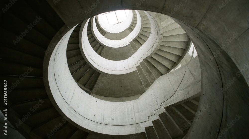 Fototapeta premium Abstract Spiral Staircase Architecture Leading Upwards to Light.