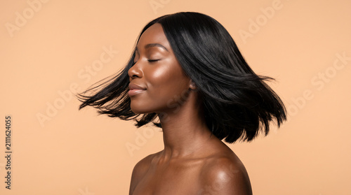 Stunning young Black woman with straight bob hair and bare shoulders, premium beauty portrait for glowing skincare and luxury cosmetics