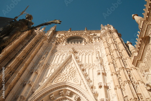  intricate exterior stonework of the Seville Cathedral, a UNESCO World Heritage site located in Seville, Spain, the largest Gothic cathedral in the world vertical