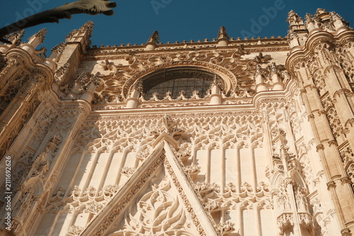  intricate exterior stonework of the Seville Cathedral, a UNESCO World Heritage site located in Seville, Spain, the largest Gothic cathedral in the world vertical