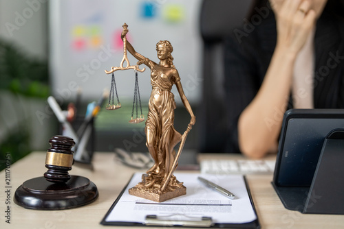 Картината върху платно Golden statue stands tall, scales balanced, holding justice