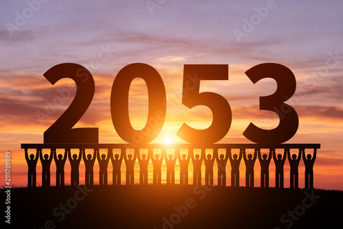 Numerous small figures silhouette in the morning sun, holding 